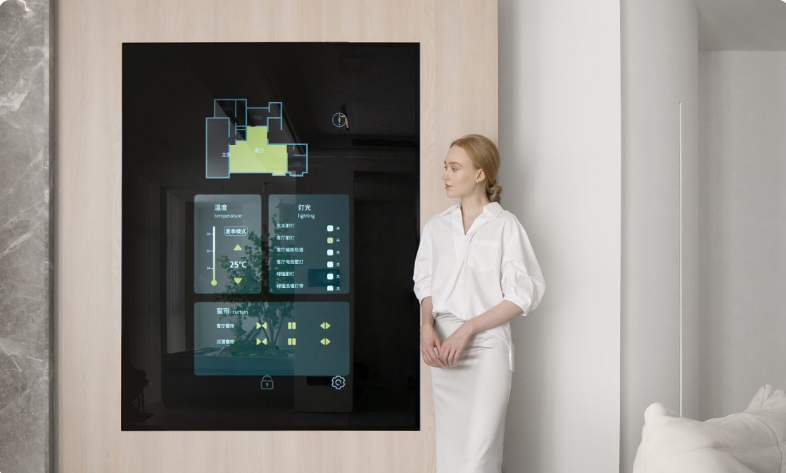 A wall-mounted climate control screen beside a woman in white